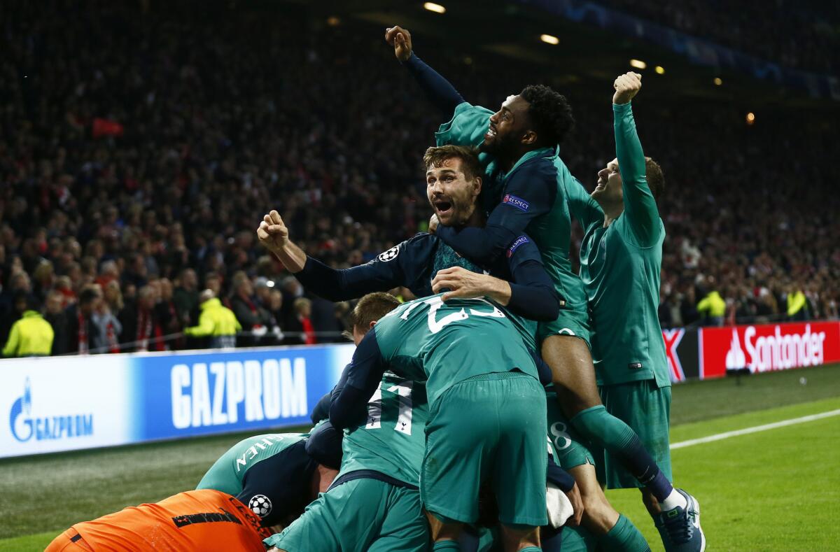 Tottenham players celebrate after scoring their third goal during the Champions League semifinal second leg soccer match between Ajax and Tottenham Hotspur at the Johan Cruyff ArenA in Amsterdam, Netherlands, Wednesday, May 8, 2019.