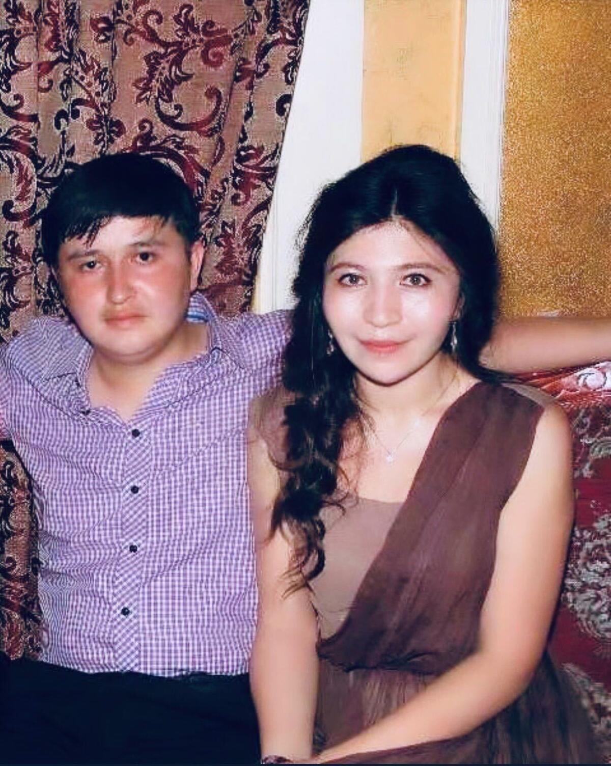 Rayhan Asat and her younger brother Ekpar Asat in 2014. 