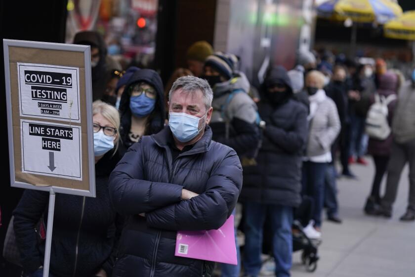 FILE - People wait in line at a COVID-19 testing site in Times Square, New York, Monday, Dec. 13, 2021. Scientists are warning that omicron’s lightning-fast spread across the globe practically ensures it won’t be the last worrisome coronavirus variant. And there’s no guarantee the next ones will cause milder illness or that vaccines will work against them. (AP Photo/Seth Wenig, File)