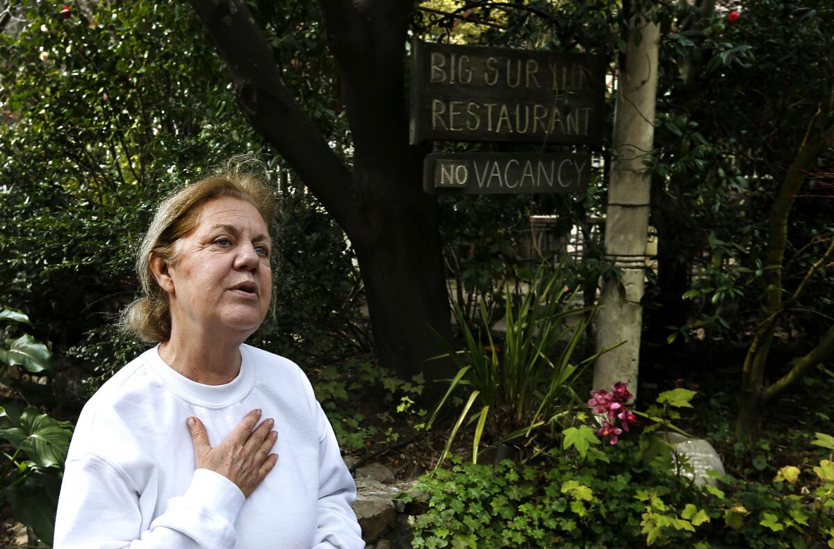 Doris Jolicoeur, 64, stands in front of Deetjen's Big Sur Inn. The historic hotel lost several cabins to falling redwoods during the winter storms. (Mel Melcon / Los Angeles Times)