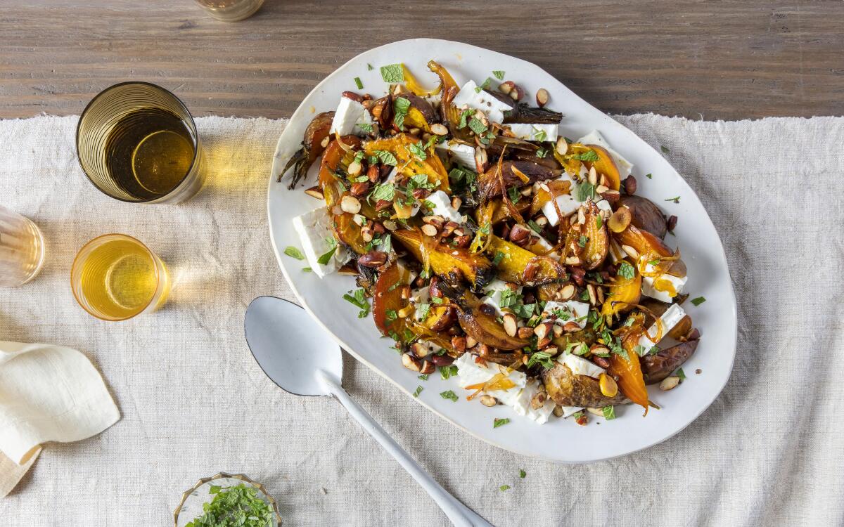Large wedges of golden beets are roasted with spicy chile oil, then layered with cool creamy feta, almonds and mint.