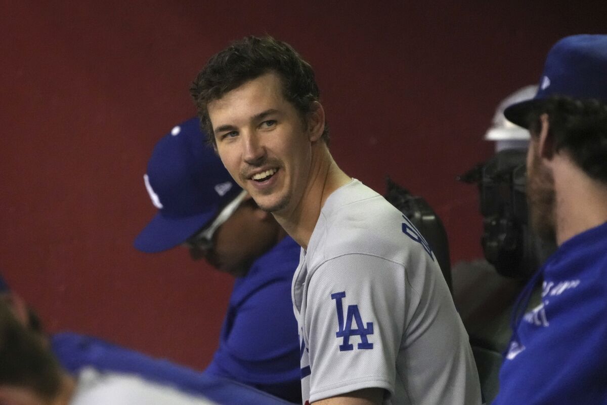 Dodgers pitcher Walker Buehler smiles in the dugout after being relieved in the eighth inning.