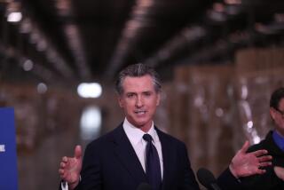 Fontana, CA - February 17: Fontana, CA - February 17: Governor Gavin Newsom speaks during a press conference to unveil the next phase of California's pandemic response in the UPS Healthcare warehouse filled with personal protective equipment in Fontana Thursday, Feb. 17, 2022. (Allen J. Schaben / Los Angeles Times)