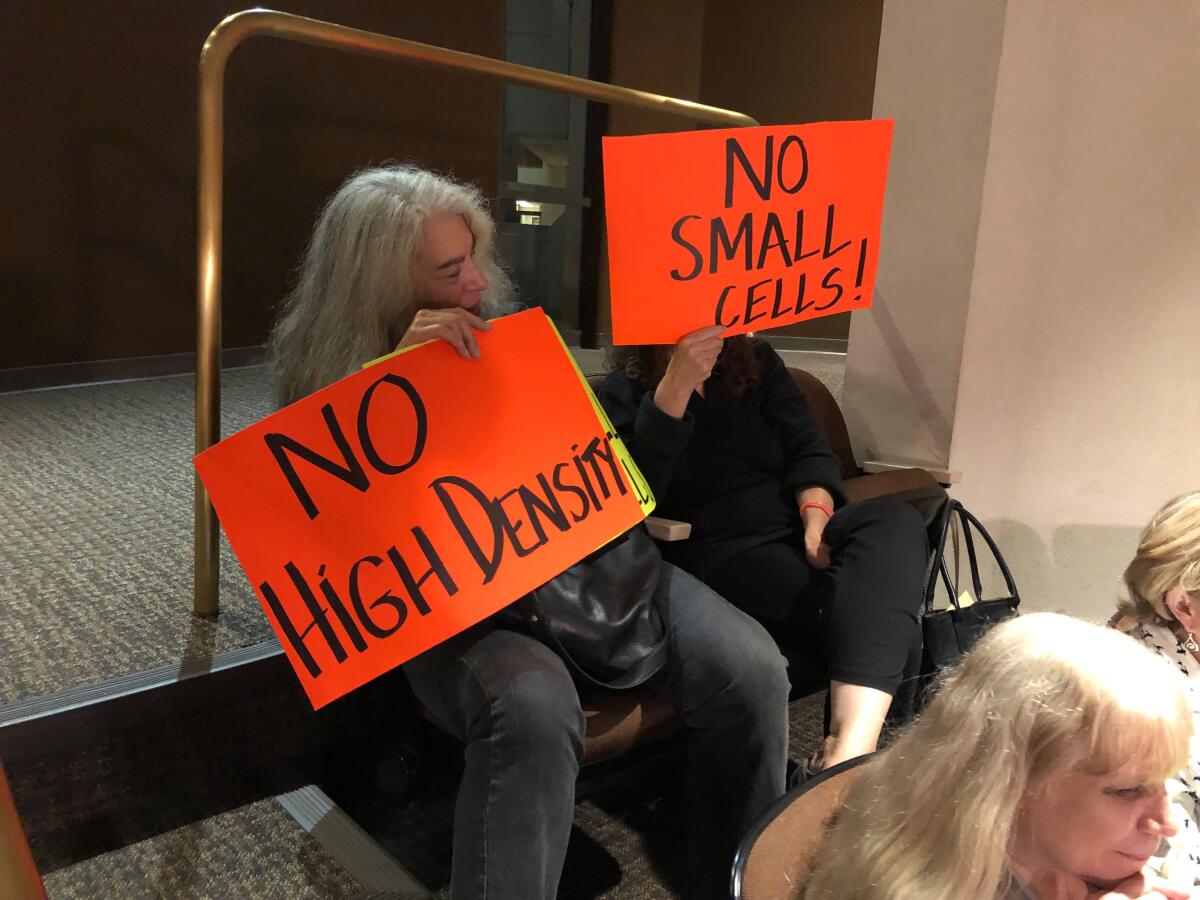 A sign at Monday's Huntington Beach City Council meeting protests any high-density development at the Magnolia Tank Farm site.