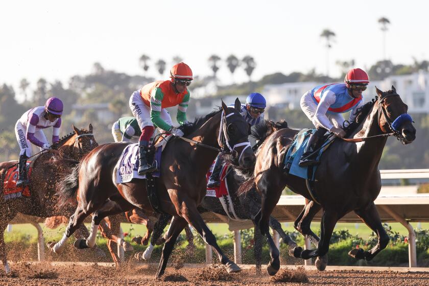 Del Mar, CA - September 02: Flavien Prat riding Arabian Knight, right, leads the pack during the Pacific Classic at Del Mar race track on Saturday, Sept. 2, 2023 in Del Mar, CA. (Meg McLaughlin / The San Diego Union-Tribune)