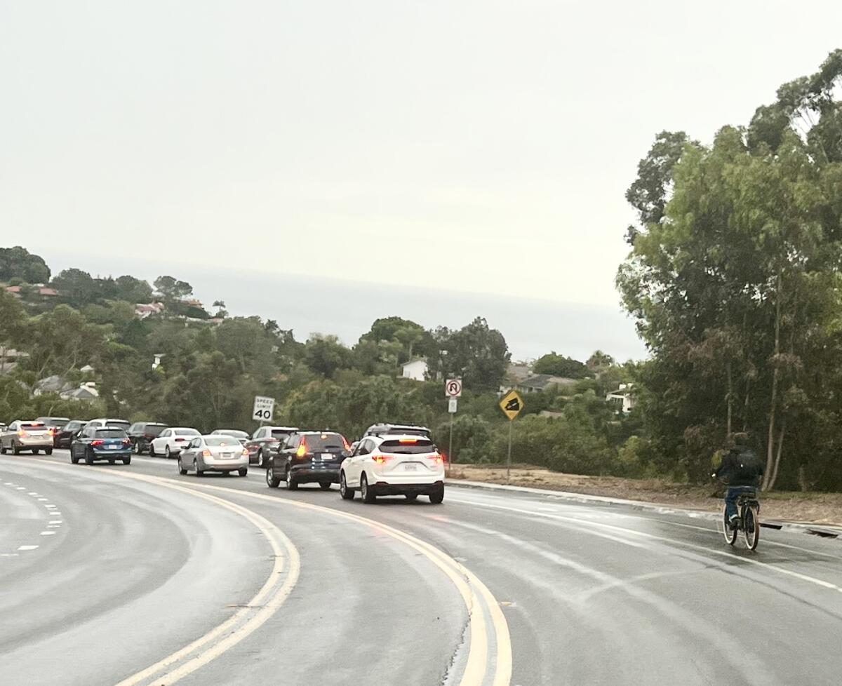 A teenage bicyclist heads down Nautilus Street in La Jolla on Sept. 9.