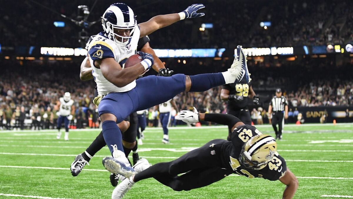 Rams running back Malcolm Brown leaps over Saints safety Marcus Williams to score a touchdown in November, 2018.