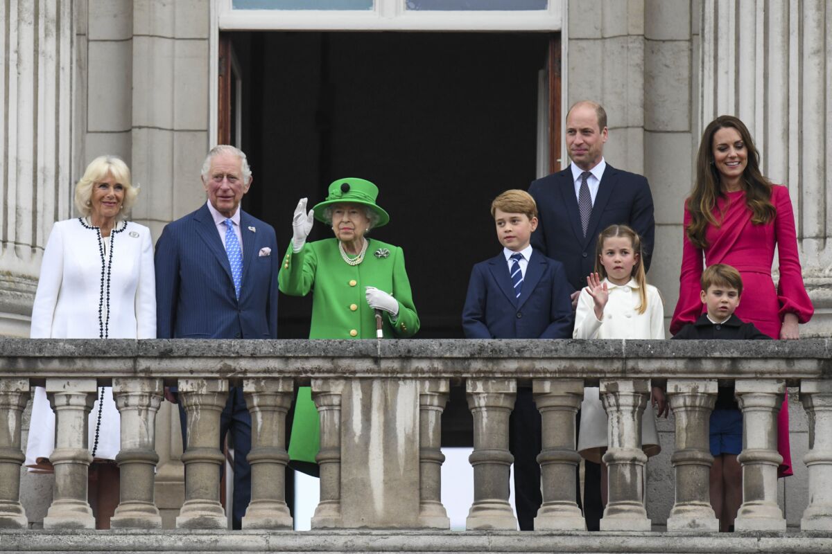 From left, Camilla, Duchess of Cornwall Prince Charles, Queen Elizabeth II, Prince George, Prince William, Princess Charlotte, Prince Louis and Kate, Duchess of Cambridge stand on the balcony, at the end of the Platinum Jubilee Pageant held outside Buckingham Palace, in London, Sunday June 5, 2022, on the last of four days of celebrations to mark the Platinum Jubilee. The pageant will be a carnival procession up The Mall featuring giant puppets and celebrities that will depict key moments from Queen Elizabeth II’s seven decades on the throne. (Roland Hoskins/Pool Photo via AP)
