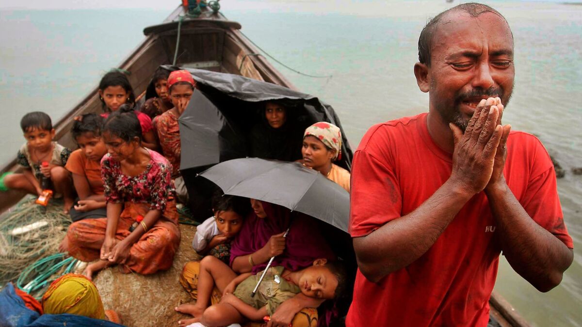 A Rohingya Muslim man and his family who fled Myanmar to Bangladesh to escape religious violence on June 13, 2012.