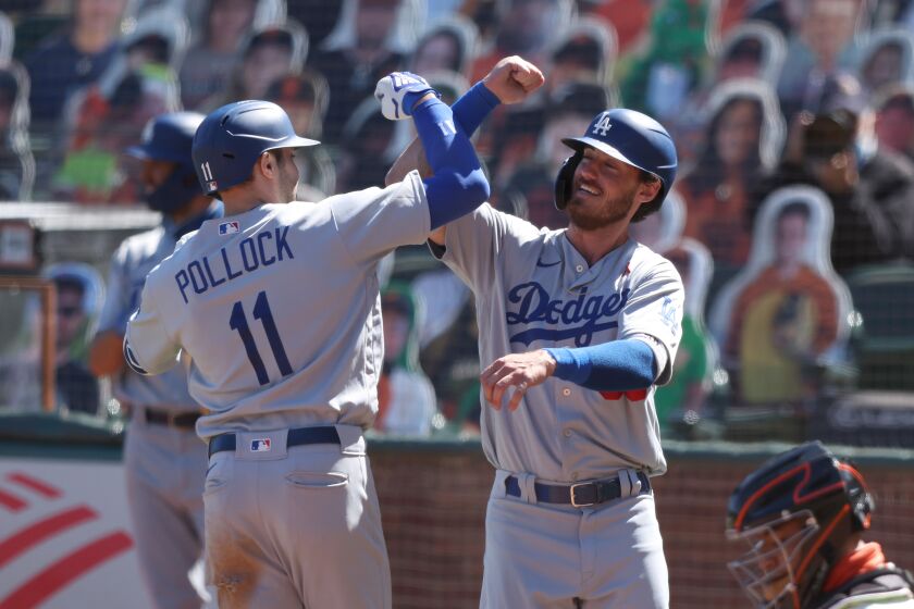 SAN FRANCISCO, CALIFORNIA - AUGUST 27: A.J. Pollock #11 of the Los Angeles Dodgers is congratulated by Cody Bellinger #35 after he hit a two run home run in the seventh inning against the San Francisco Giants at Oracle Park on August 27, 2020 in San Francisco, California. (Photo by Ezra Shaw/Getty Images)