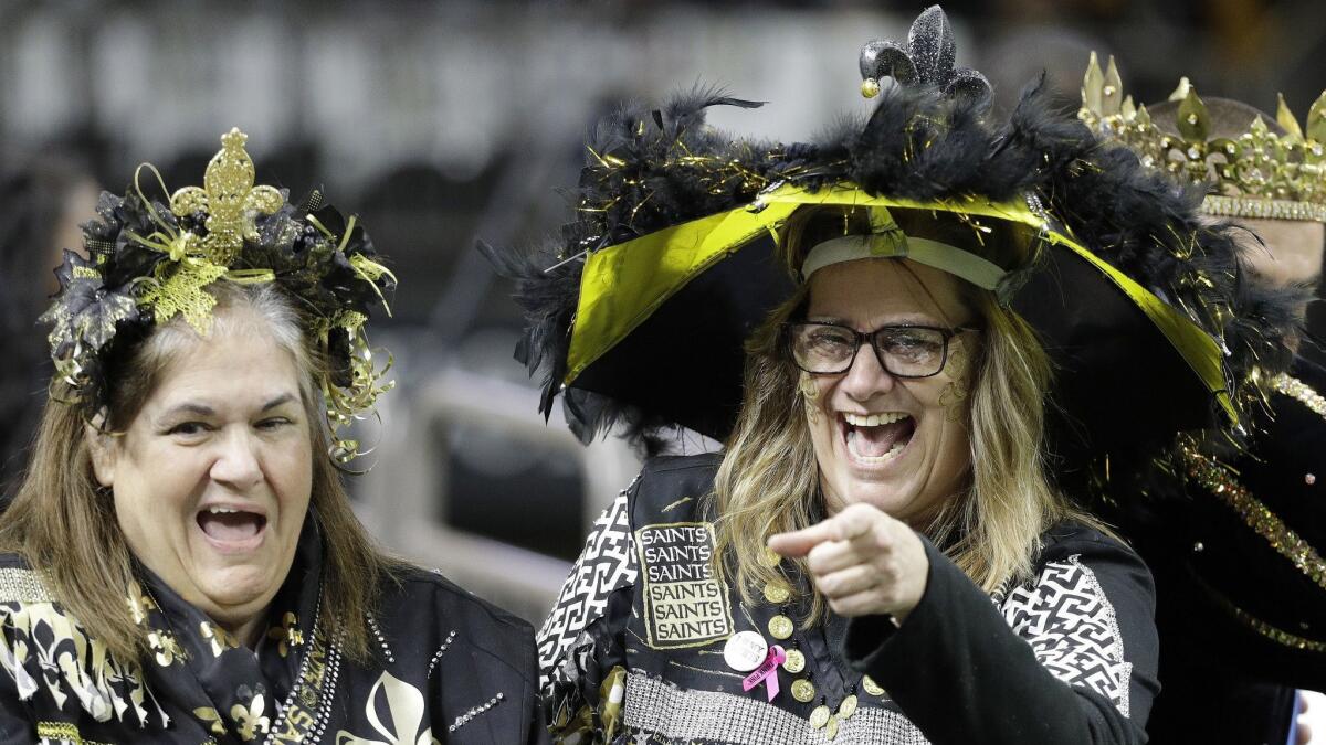 Saints fans gather at the Mercedes-Benz Superdome before Sunday's NFC championship game against the Rams.