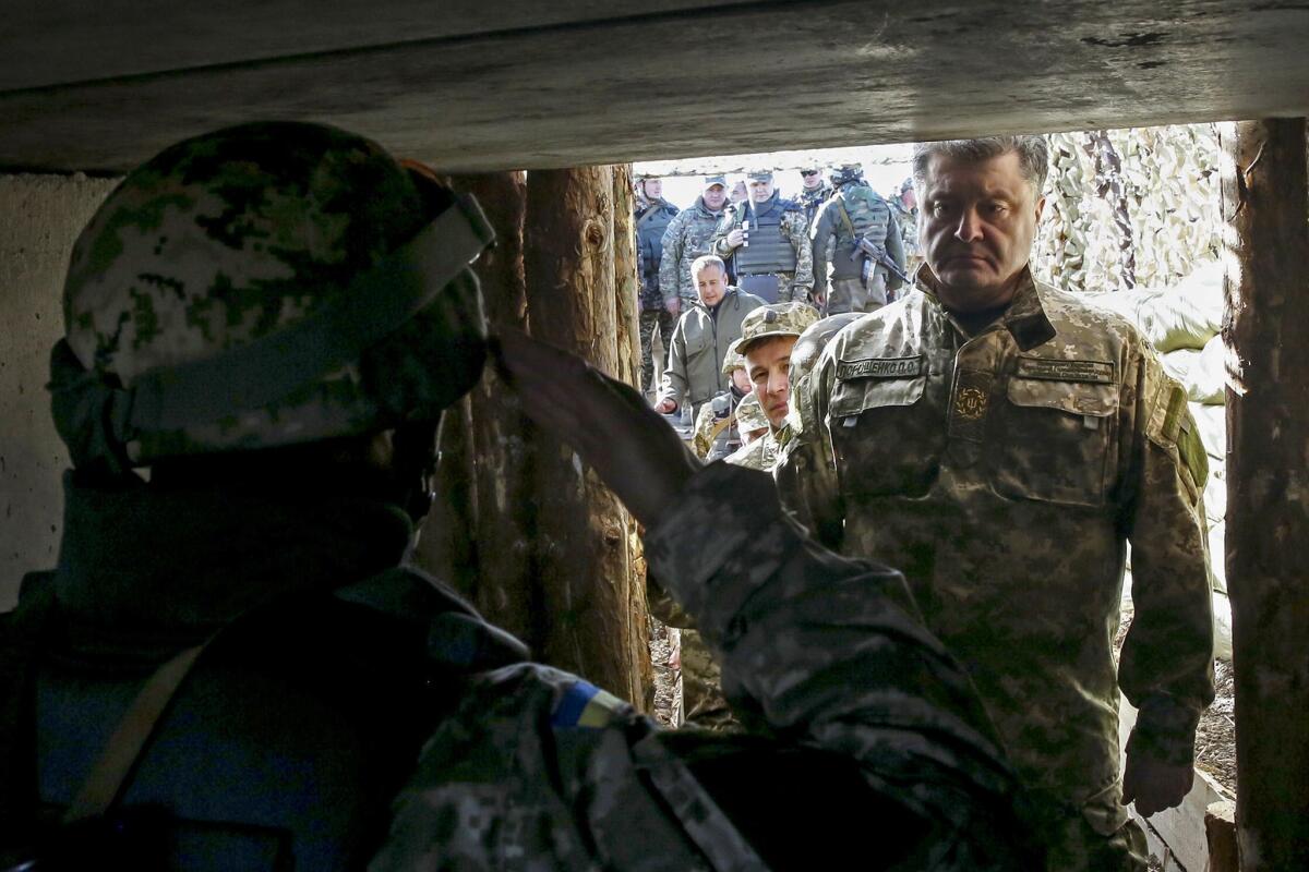 Ukrainian President Petro Poroshenko visits troops on the front line against pro-Russia separatists on Oct. 10 in Kurahovo, in the Donetsk region.