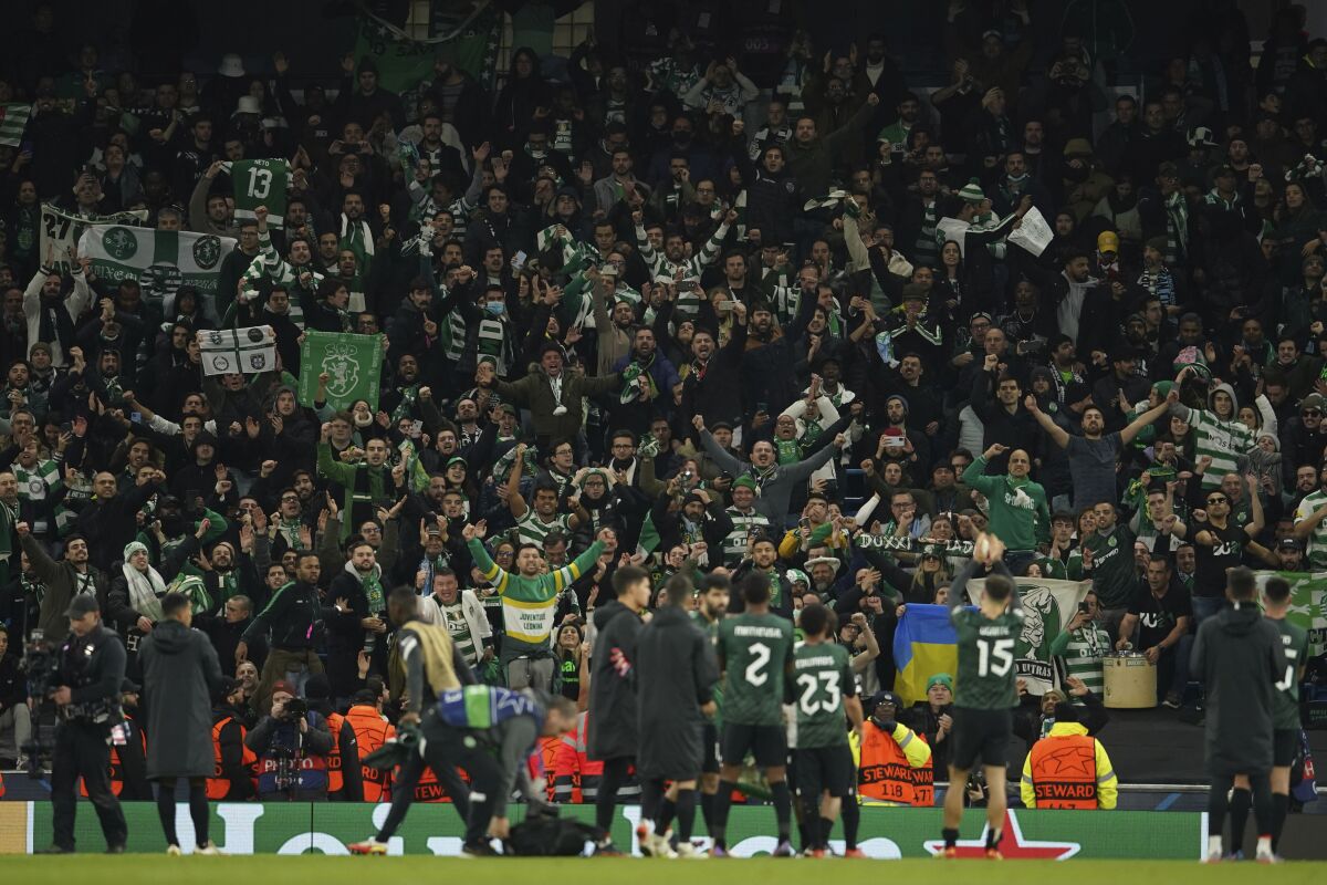 Sporting players greet their supporters after the Champions League round of 16 second leg soccer match between Manchester City and Sporting Lisbon at the City of Manchester Stadium in Manchester, England, Wednesday, March 9, 2022. (AP Photo/Dave Thompson)