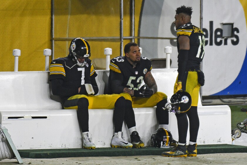Pittsburgh Steelers quarterback Ben Roethlisberger (7) and center Maurkice Pouncey (53) sit on the bench as they talk with wide receiver JuJu Smith-Schuster (19) following a 48-37 loss to the Cleveland Browns in an NFL wild-card playoff football game in Pittsburgh, late Sunday, Jan. 10, 2021. (AP Photo/Don Wright)