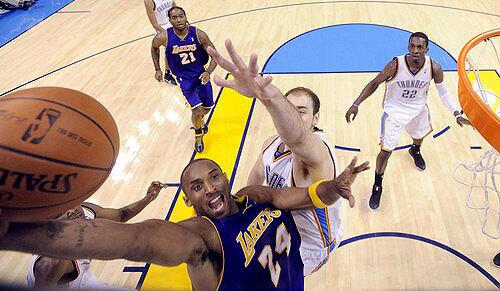 Lakers guard Kobe Bryant scores on a driving layup against Thunder center Nenad Krstic in the fourth quarter Tuesday night.