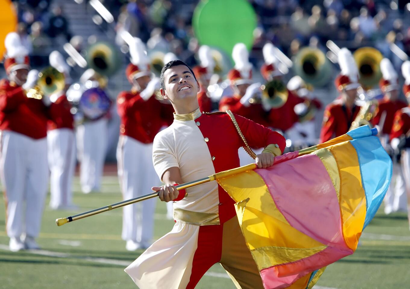 Pasadena City College Tournament of Roses Honor Band color guard member Andy de la Rosa, 21 of Compton, entertains the crowds gathered for Bandfest 2012 at Pasadena City College Robinson Stadium on Saturday, December 31, 2011. Seven bands from throughout the nation and the world participated in the morning festivities.