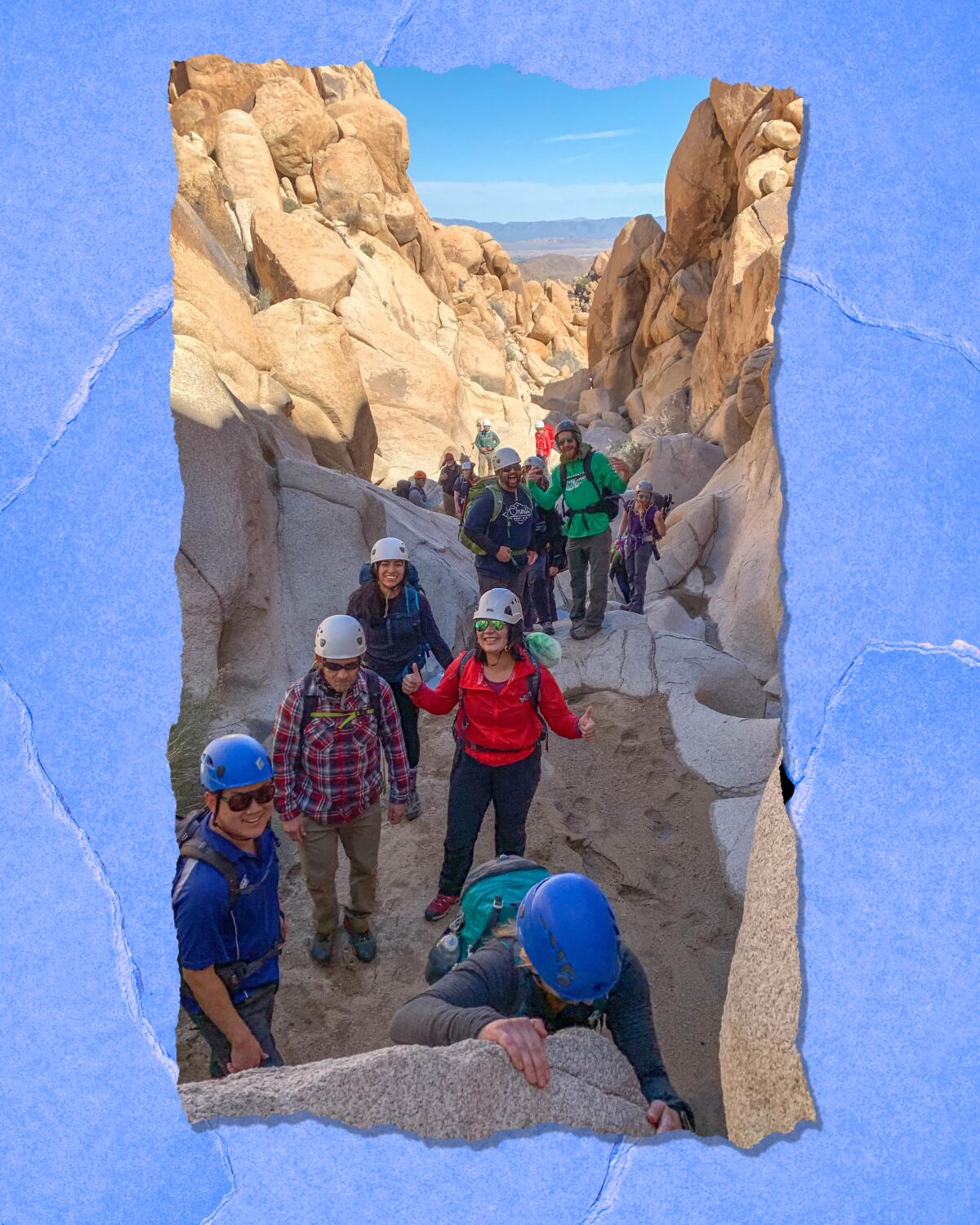 People in hard hats gather on a trail.