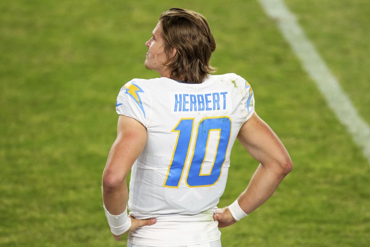  Chargers quarterback Justin Herbert (10) stands on the sideline.
