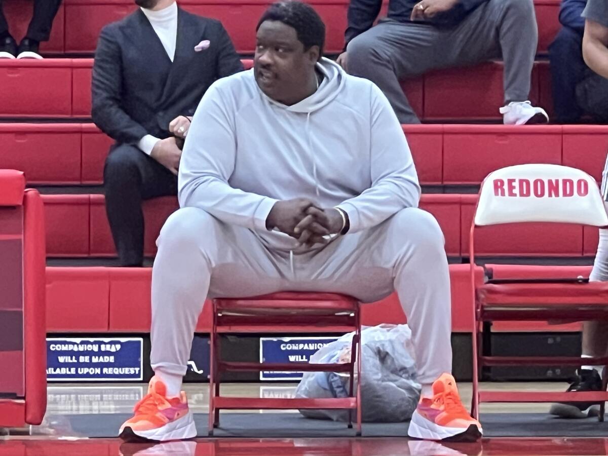 Beverly Hills High basketball coach Jarvis Turner sits on the bench.