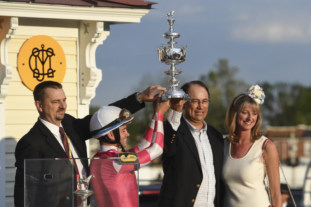 Rombauer trainer Mike McCarthy, jockey Flavien Prat and horse owners John and Diane Fradkin celebrate.