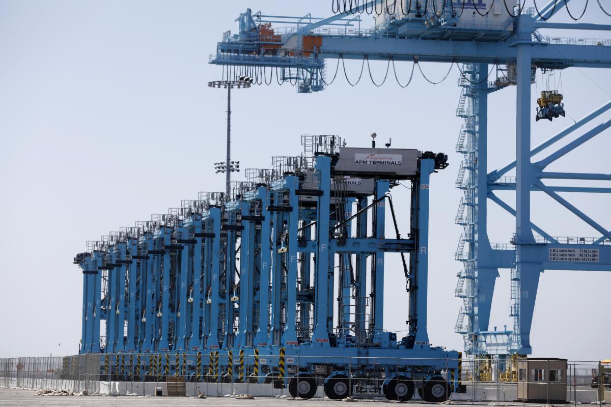 The first of 100 robot straddle carriers are delivered by a ship-to-shore crane to Maersk’s APM terminal in July.
