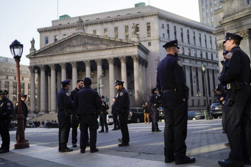 New York Police officers wait for instructions around the courthouse ahead of former President Donald Trump's anticipated indictment on Tuesday, March 21, 2023, in New York. A New York grand jury investigating Trump over a hush money payment to a porn star appears poised to complete its work soon as law enforcement officials make preparations for possible unrest in the event of an indictment. (AP Photo/Eduardo Munoz Alvarez)