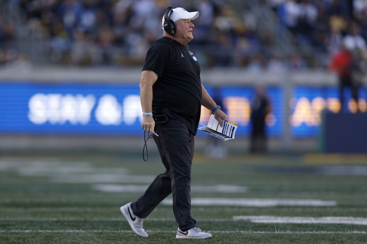 UCLA coach Chip Kelly stands on the field during the second half Nov. 25, 2022.