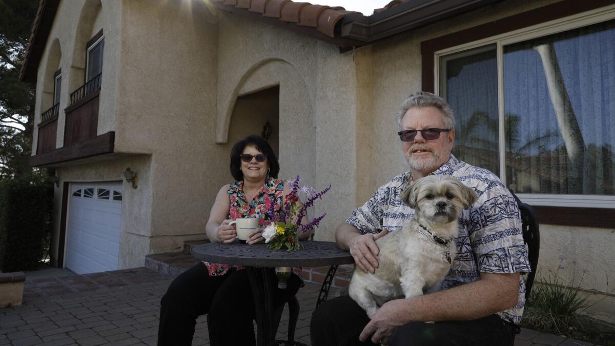 Robert Holland, with his wife, Lorie, is a 63-year-old in Tujunga who supports Proposition 5. Holland wants to sell the three-story house that they bought in 1995 and buy a one-story place. They could benefit greatly from the tax break offered if the measure passes.