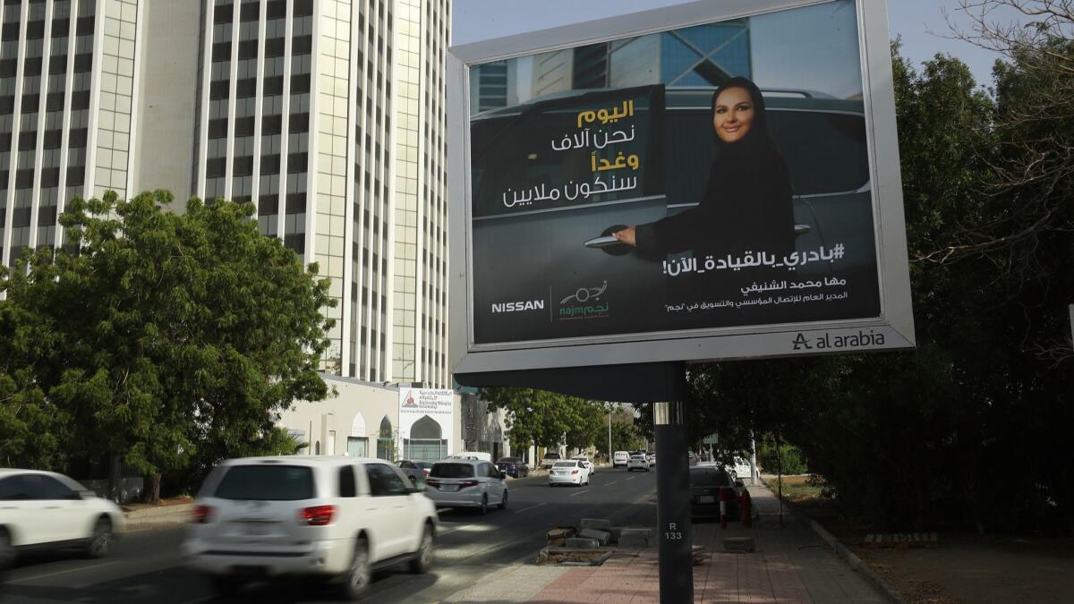 A billboard in Jidda, Saudi Arabia, for Japanese automaker Nissan shows a woman about to get into a car on the day women were legally allowed to drive in Saudi Arabia on June 24.