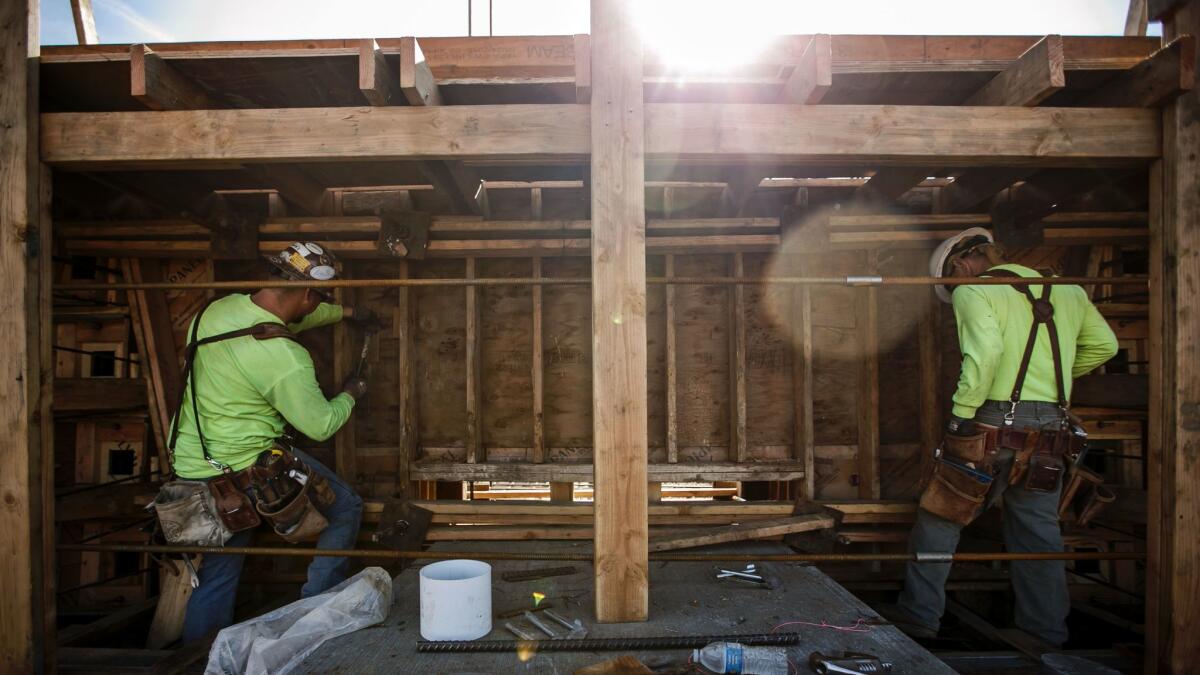 Carpenters in January work on a viaduct being built over Highway 99 in Fresno County as part of the California high-speed rail project.