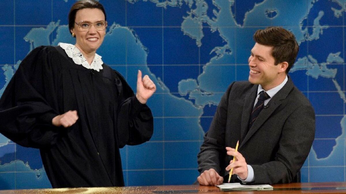 Kate McKinnon, shown portraying Ruth Bader Ginsburg, and Colin Jost appear in a segment of 'SNL's' Weekend Update.