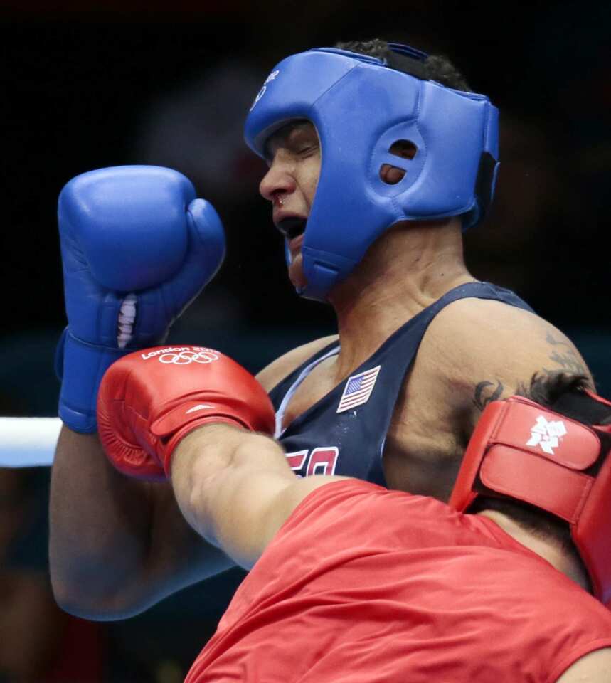 Russia's Magomed Omarov, foreground, fights Dominic Breazeale of the U.S. during their super heavyweight (over 91kg) boxing match.