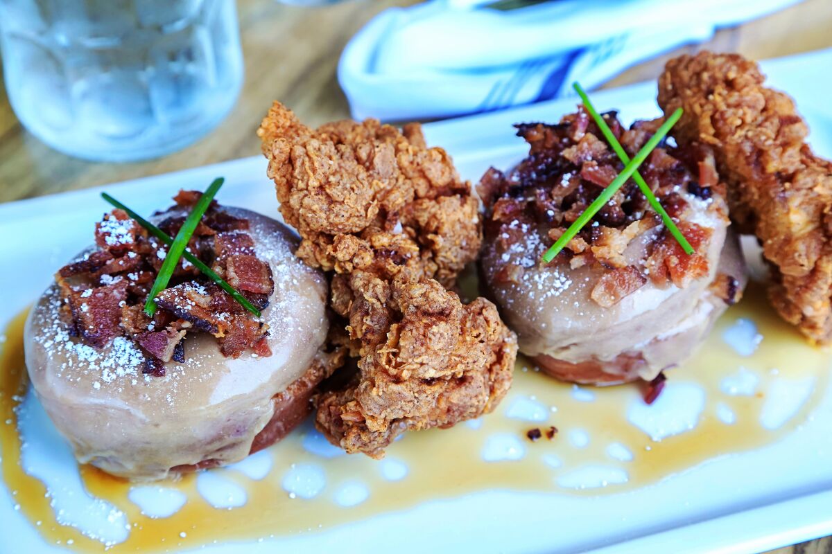 Eduardo Contreras  U-t The Buttermilk Fried Chicken With Maple Bacon Donuts dish at Great Maple at Westfield UTC.