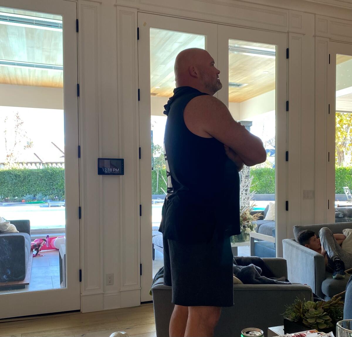 Andrew Whitworth stands in his home watching the Rams play the Vikings because of COVID test results.