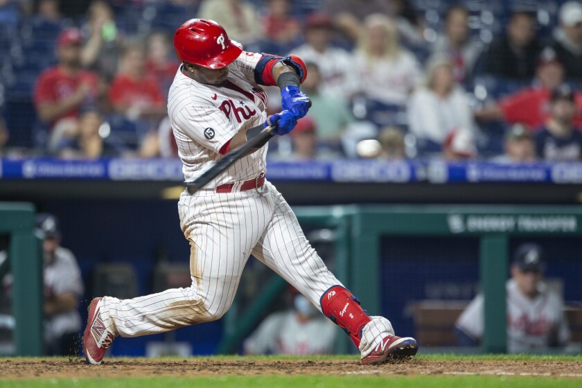 Philadelphia Phillies' Jean Segura hits an RBI double during the fifth inning of the team's baseball game against the Atlanta Braves, Tuesday, June 8, 2021, in Philadelphia. (AP Photo/Laurence Kesterson)
