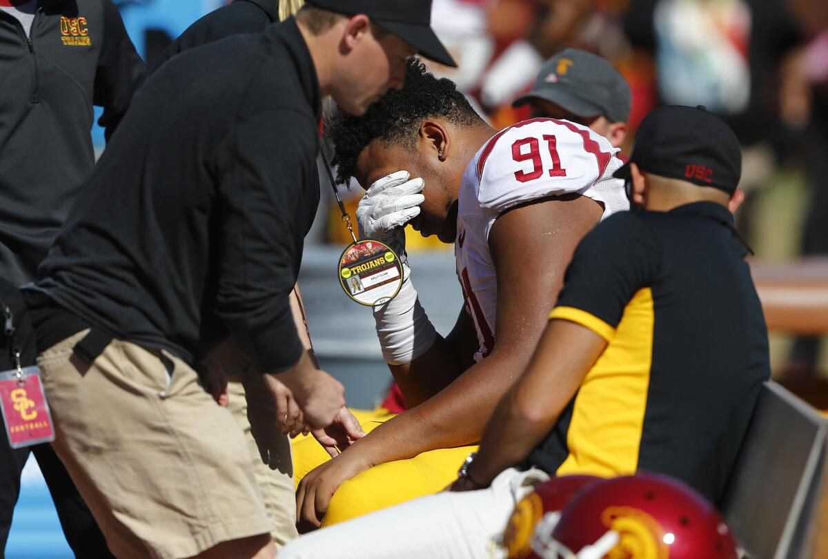 Defensive tackle Noah Jefferson (91) is examined on the bench after injuring an arm during USC's spring game