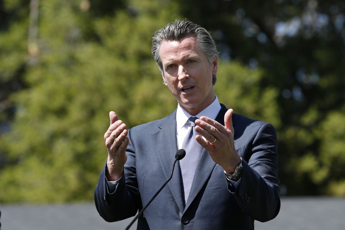 Gov. Gavin Newsom discuses California's efforts to convert hotels and motels into isolation housing for the homeless threatened by the coronavirus during an April 3 news conference near Sacramento.