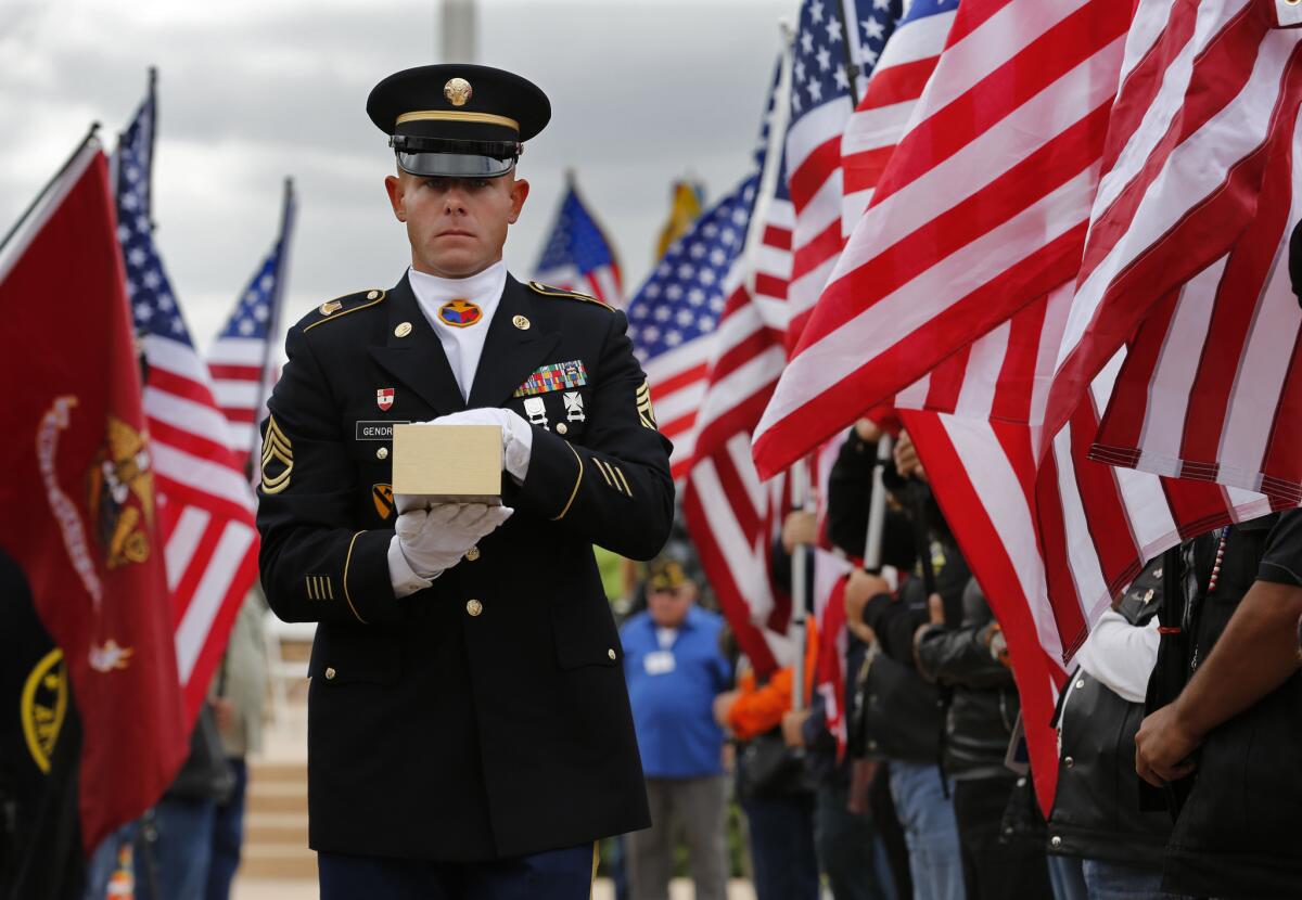 Army Sgt. 1st Class Joshua Gendron carries the remains of Army Sgt. Charles Schroeter during a service with full military honors Thursday at Miramar National Cemetery in San Diego. Schroeter’s remains were located only recently.