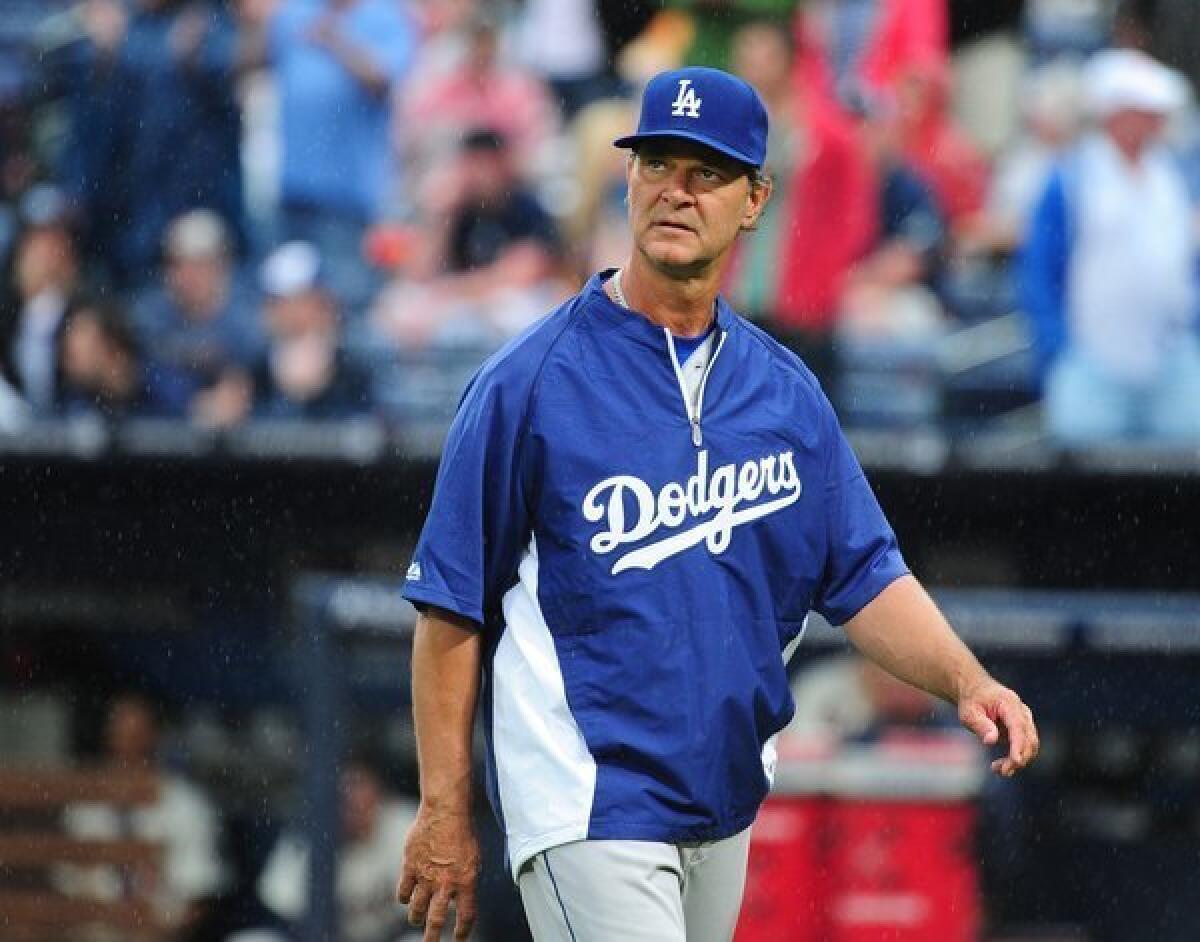 Dodgers Manager Don Mattingly heads back to the dugout after making a pitching change against the Atlanta Braves at Turner Field.