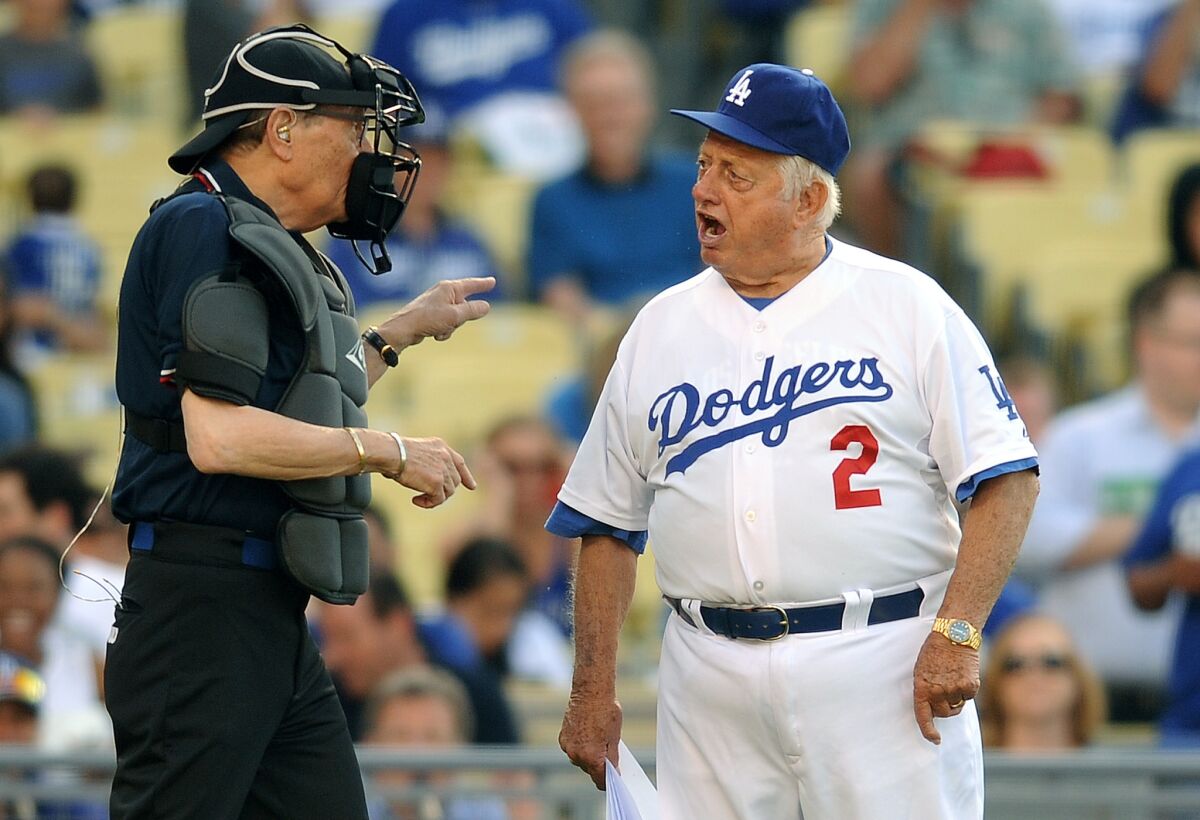 Former Dodgers manager Tommy Lasorda argues with umpire and television personality Larry King at an old-timers game in 2013.