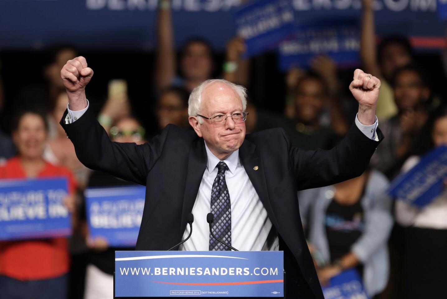 Democratic presidential candidate, Sen. Bernie Sanders acknowledges his supporters on arrival at a campaign rally.