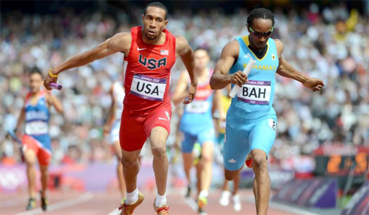 Bryshon Nellum and the Bahamas' Chris Brown compete in a men's 4X400m relay heats during the London 2012 Olympic Games on August 9, 2012.