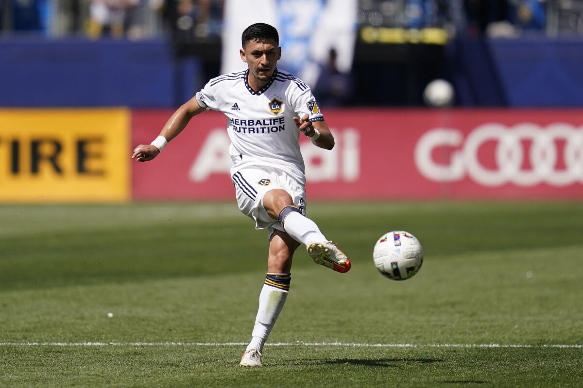 Los Angeles Galaxy midfielder Mark Delgado (8) shoots during an MLS soccer match.