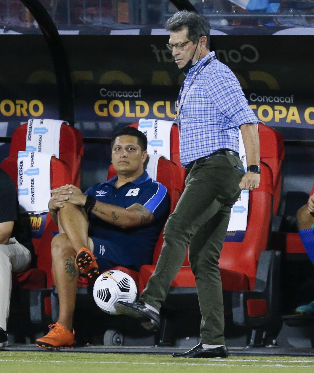 El Salvador head coach Hugo Perez stops an out of bounds ball