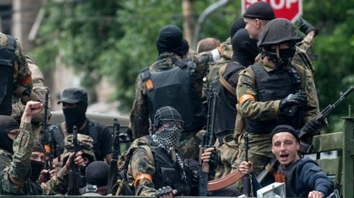 Ukrainian troops leave the site of a battle in Mariupol, eastern Ukraine, in June 2014.