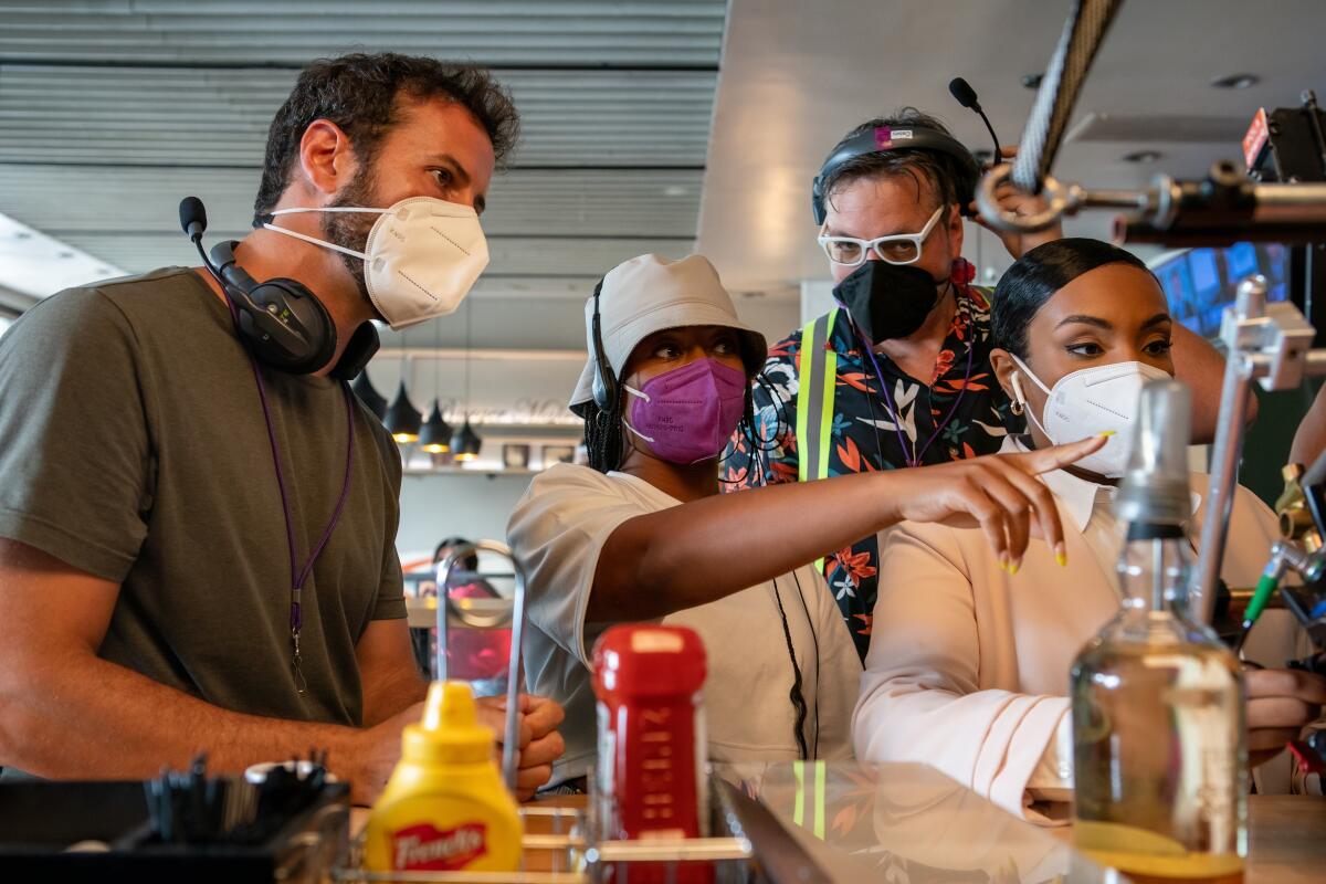 A group of masked people on a TV set