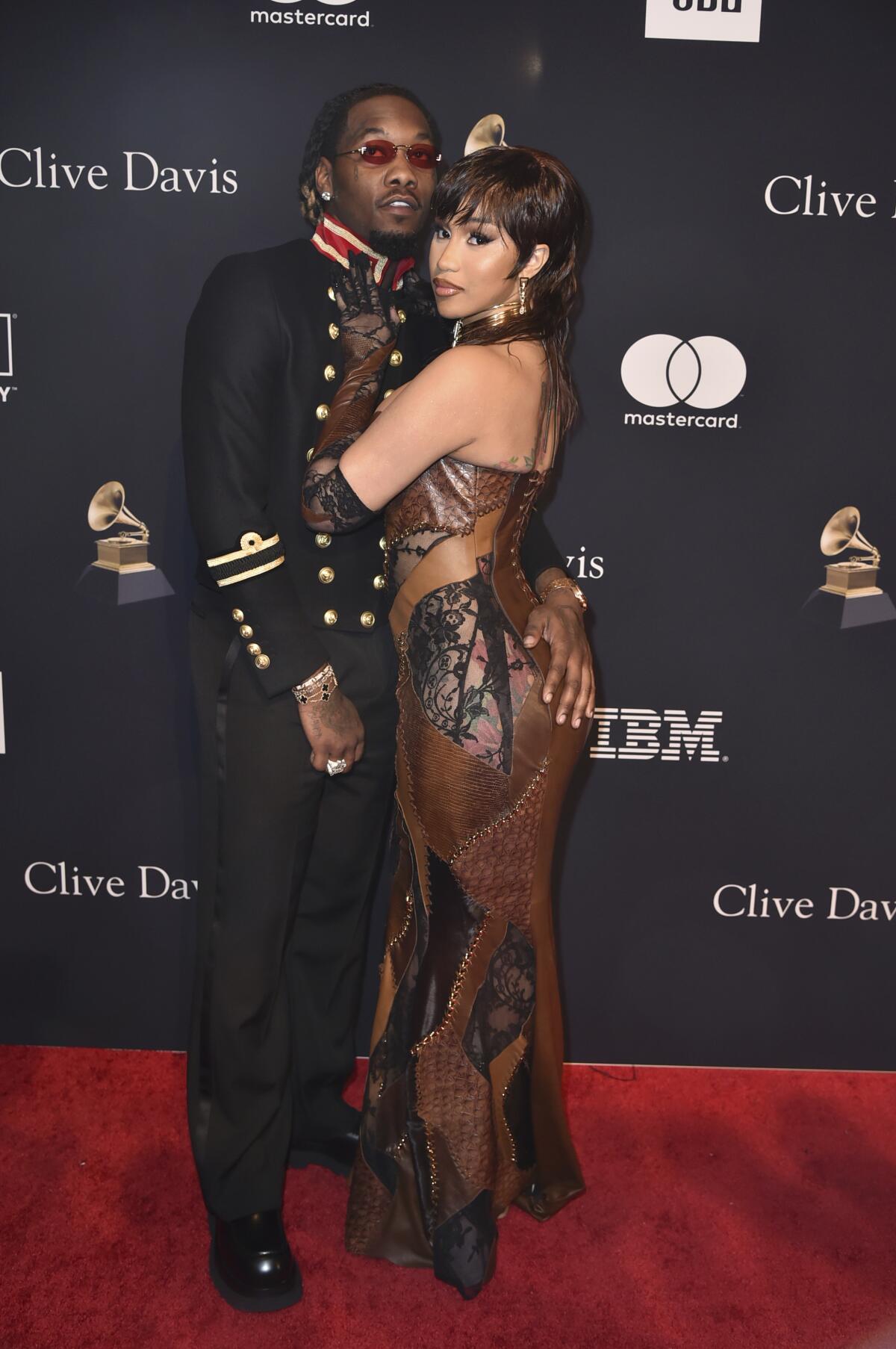 Cardi B faces Offset with her arms around his waist as both arrive styled for a pre-Grammys party