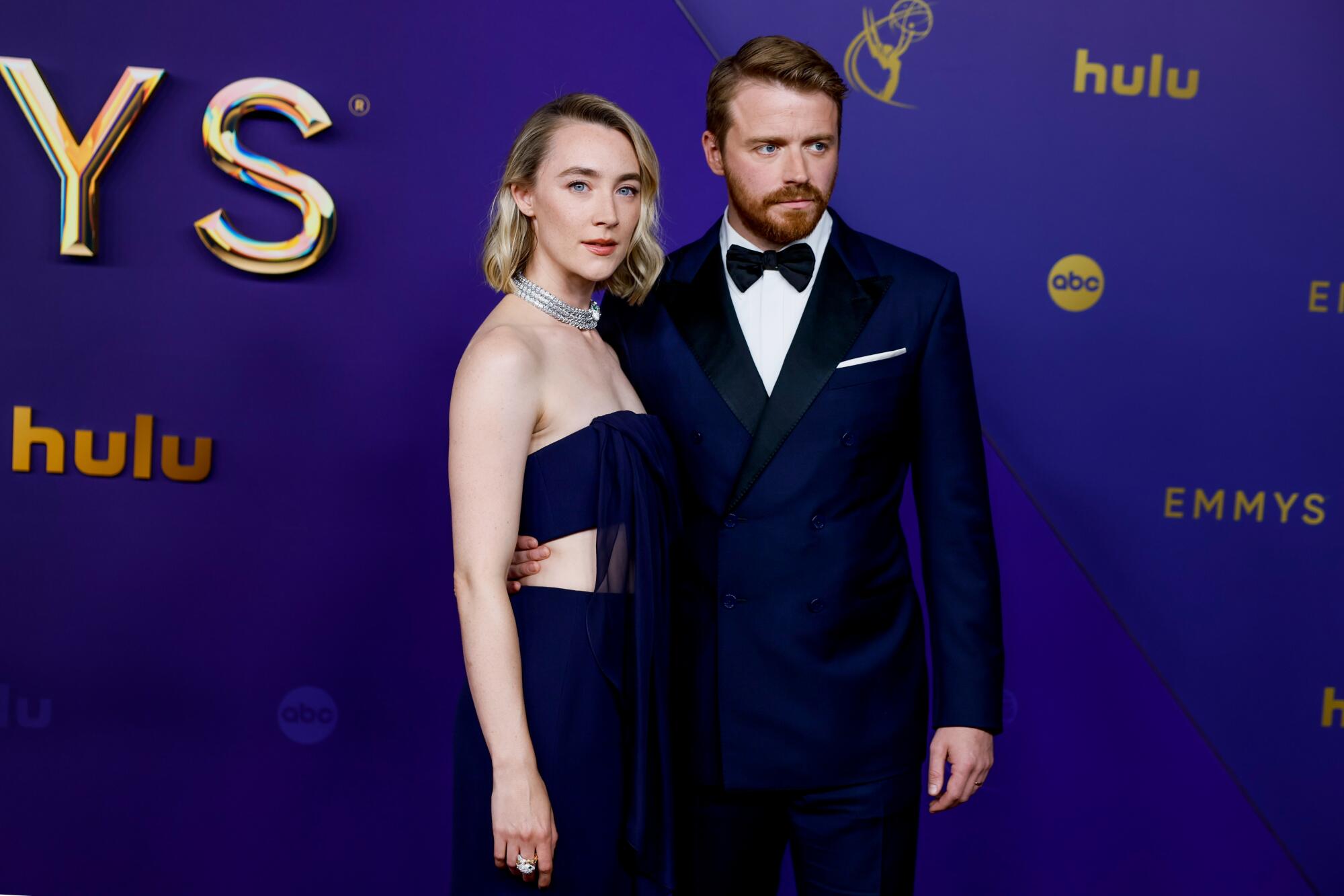 Saoirse Ronan and Jack Lowden pose on the red carpet.