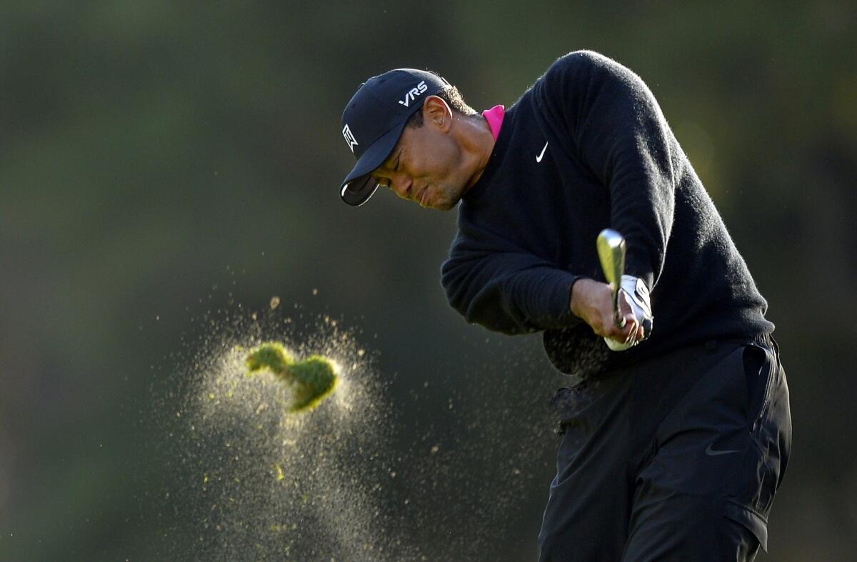 Tiger Woods hits his approach shot to the 18th hole during the second round of the Northwestern Mutual World Challenge at Sherwood Country Club in Thousand Oaks on Friday.