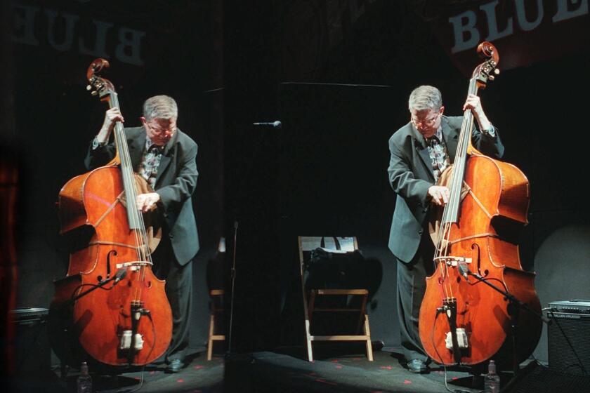 Jazz bassist Charlie Haden, right, and his plexiglas reflection during a sound check at the House of Blues in West Hollywood before a performance by his band Quartet West in 1997.